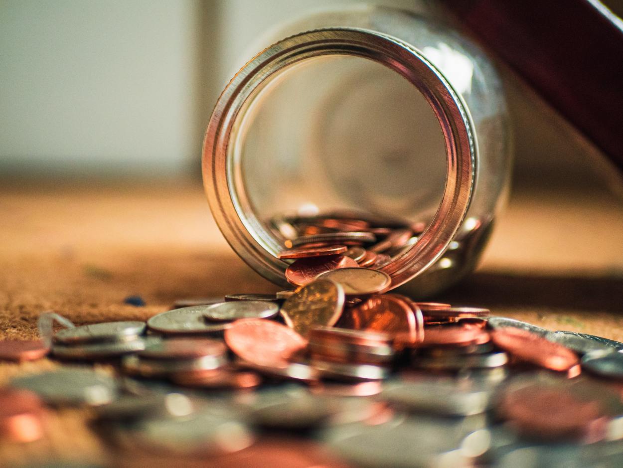 Coins spilling from jar