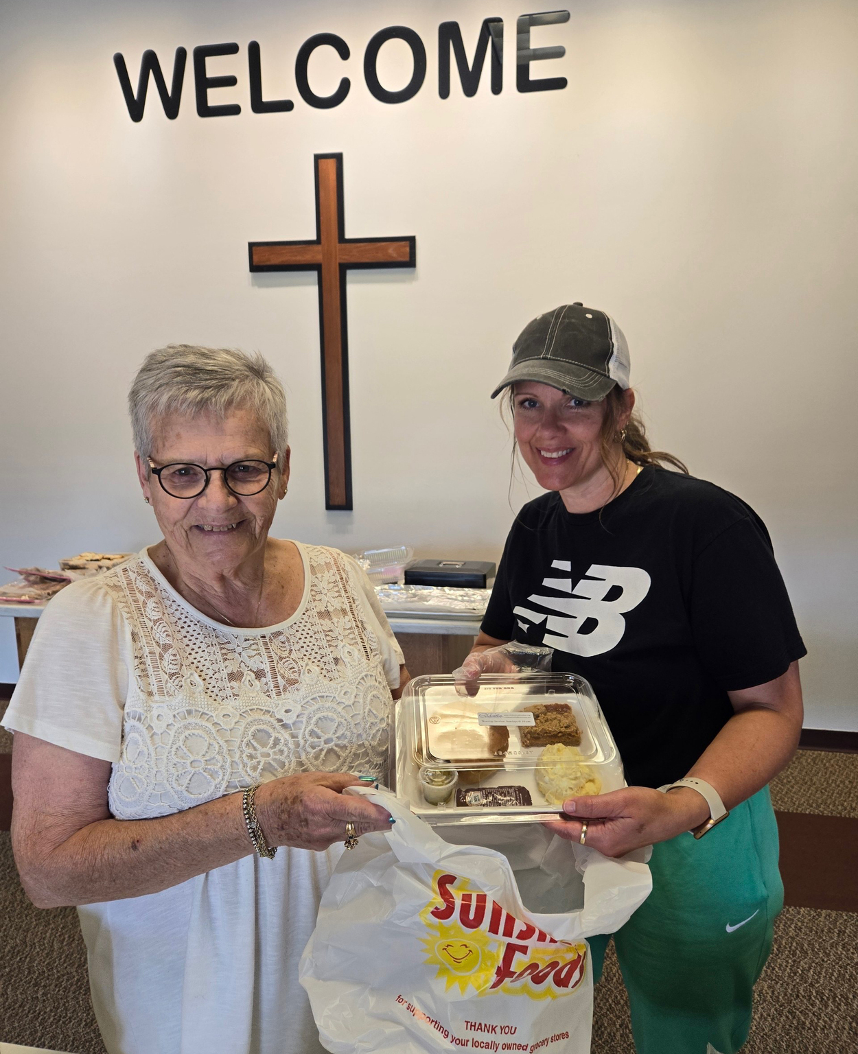 Two people showing a packaged meal