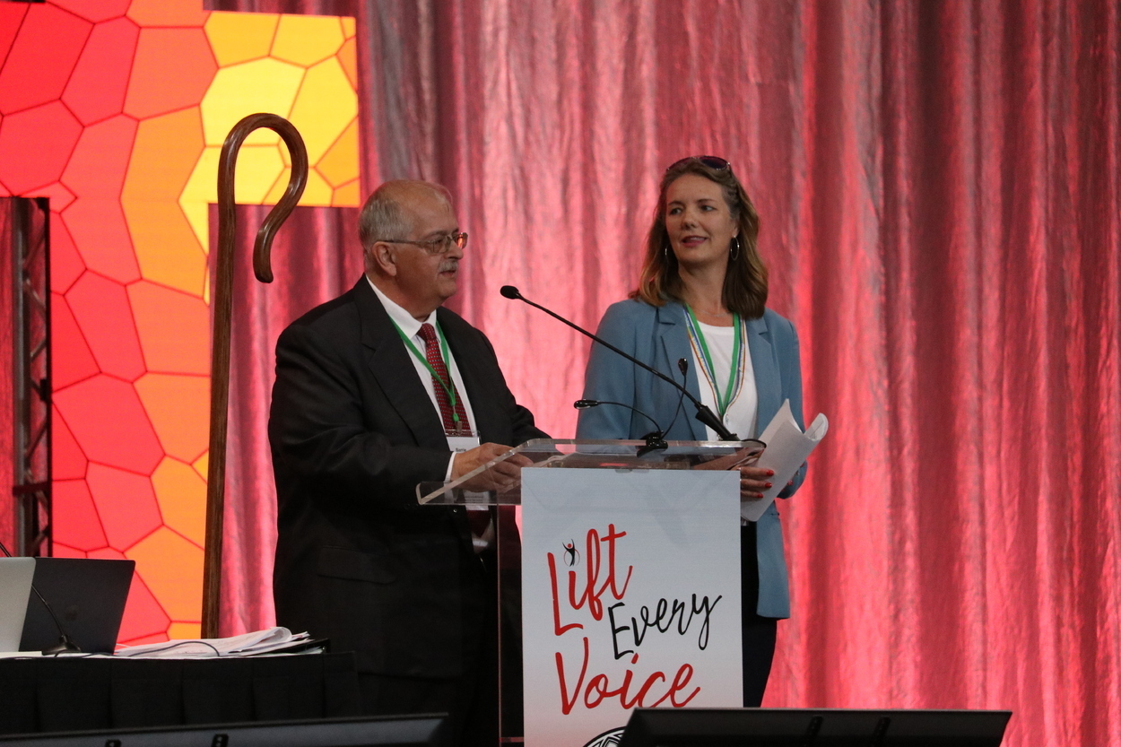 Rev. Tritle and Beata Ferris at the podium