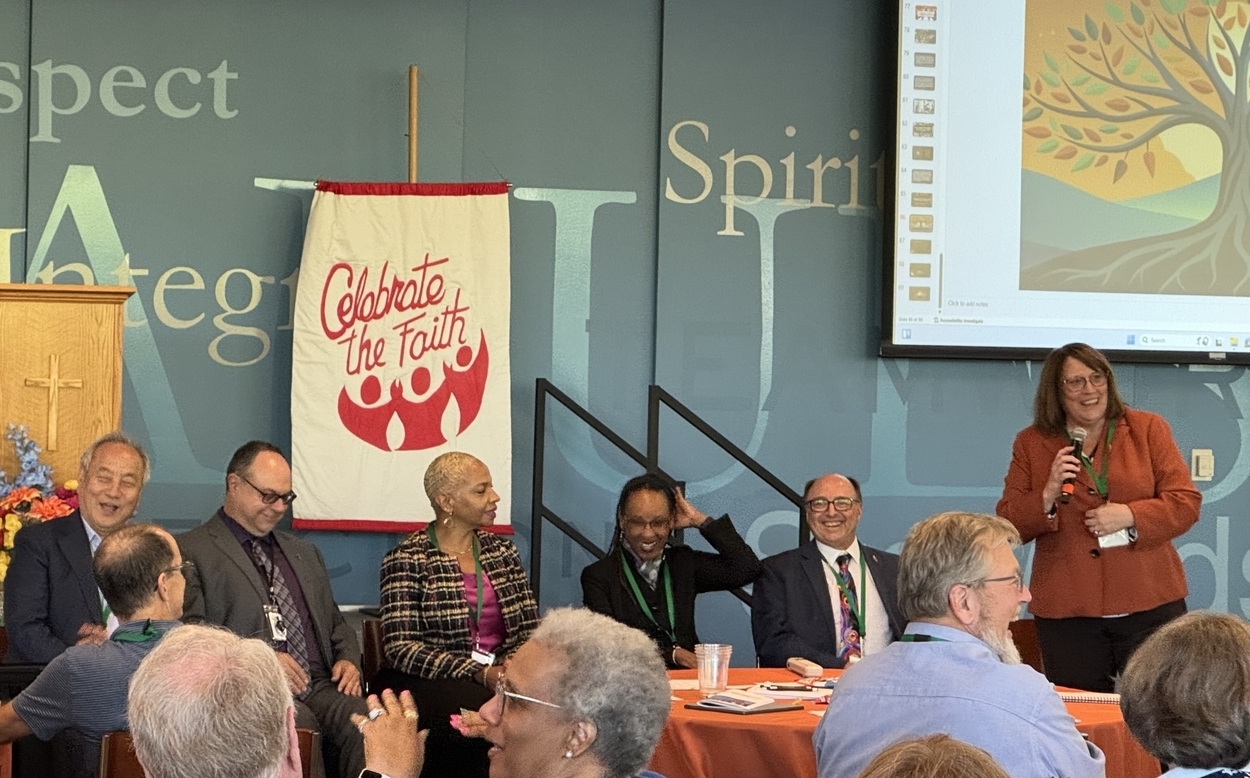 Bishop Plambeck speaks next to seated NCJ bishops